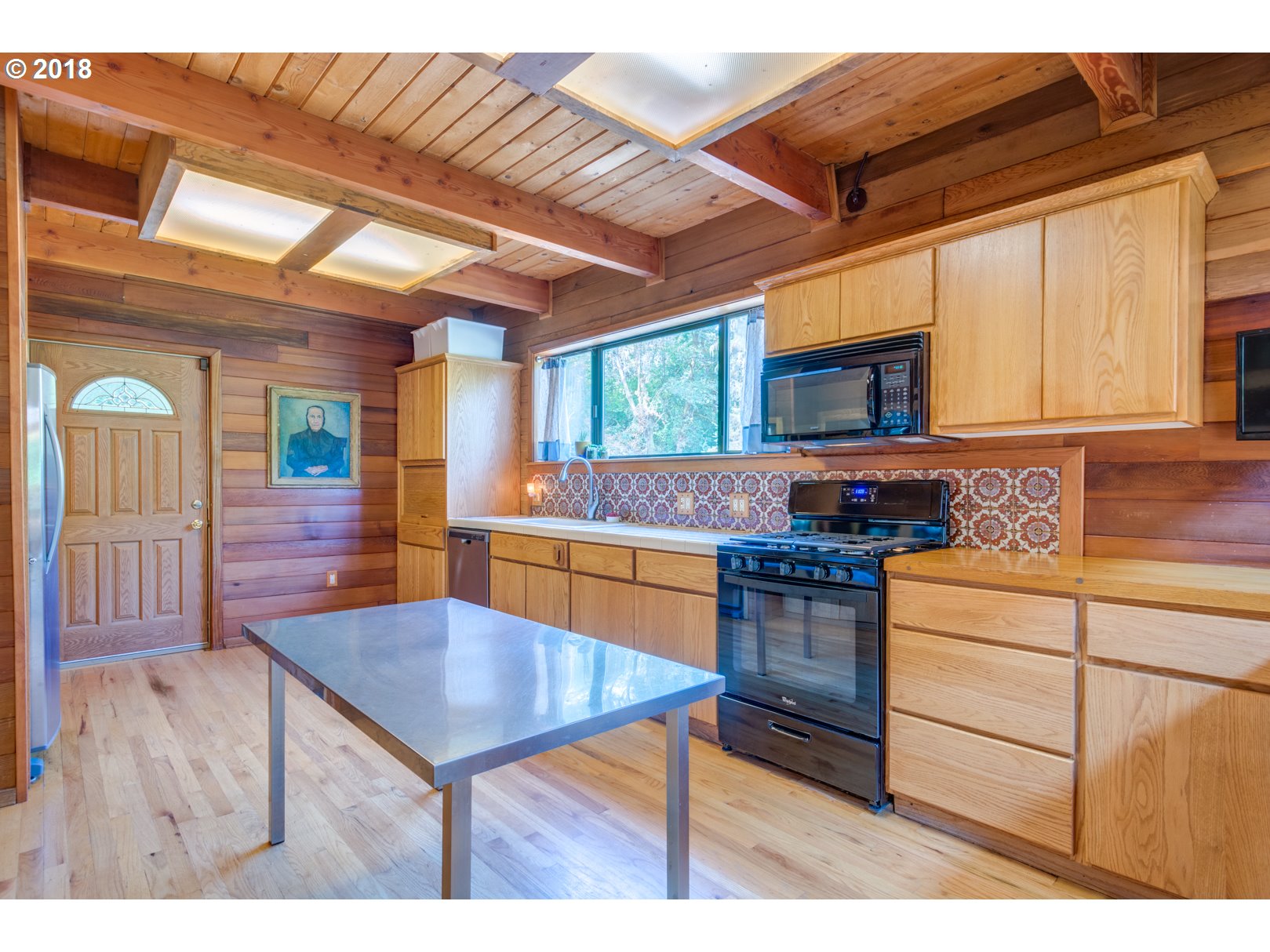 66794 Doetsch Road Deer Island, OR 97054 - Photo 5 of 32 a kitchen with stainless steel appliances wooden cabinets sink and stove