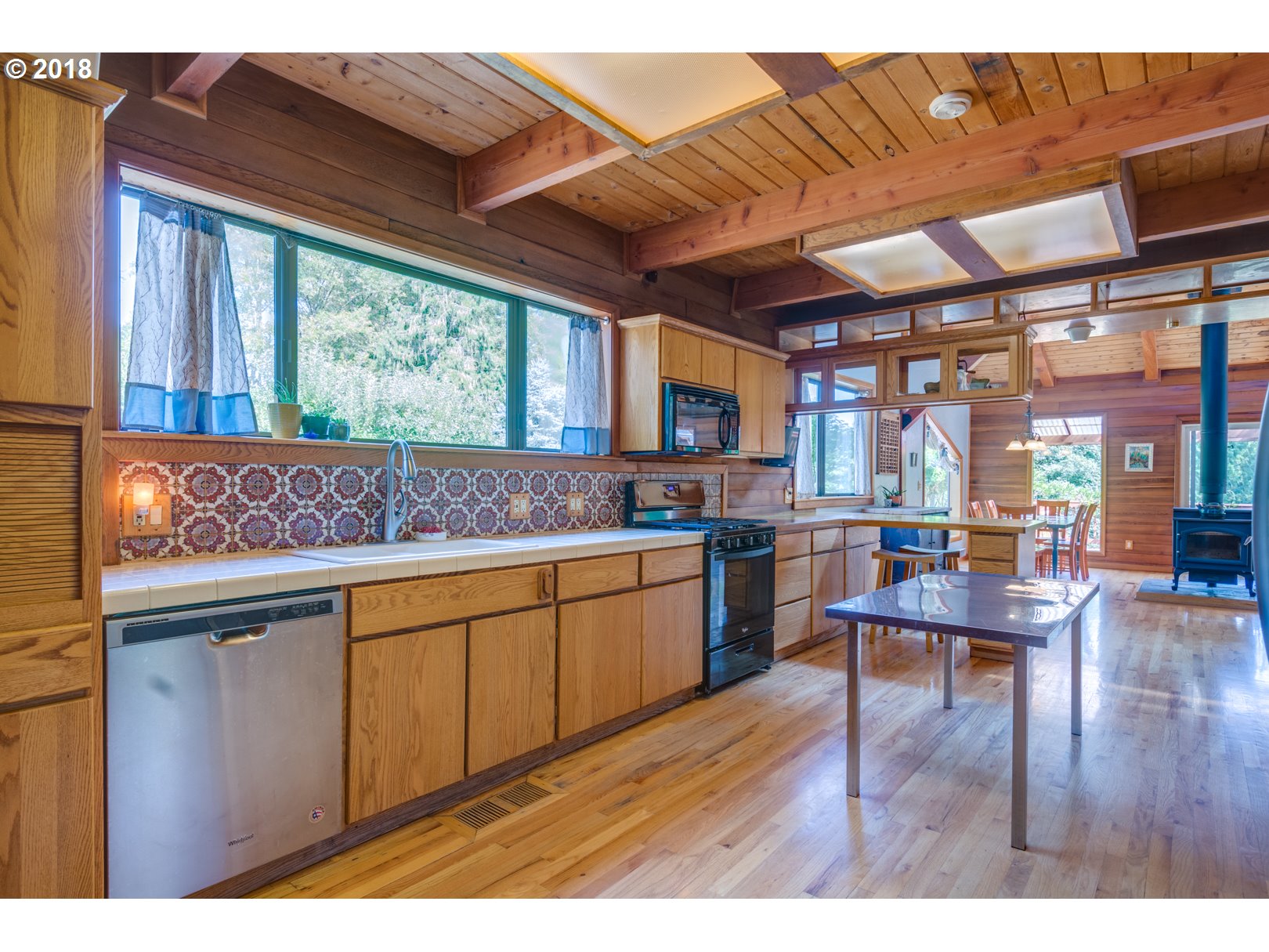 66794 Doetsch Road Deer Island, OR 97054 - Photo 7 of 32 a living room with stainless steel appliances granite countertop a kitchen island wooden floors and a large window