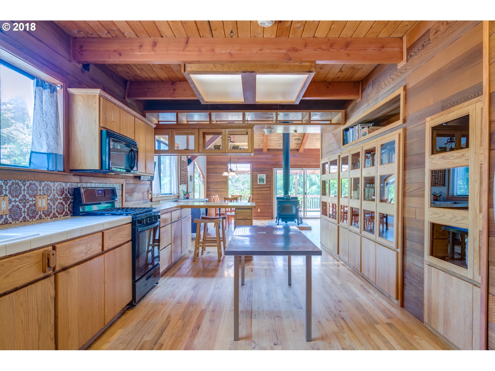 66794 Doetsch Road Deer Island, OR 97054 - Photo 8 of 32 a open kitchen with stainless steel appliances granite countertop a stove top oven a dining table and chairs with wooden floor