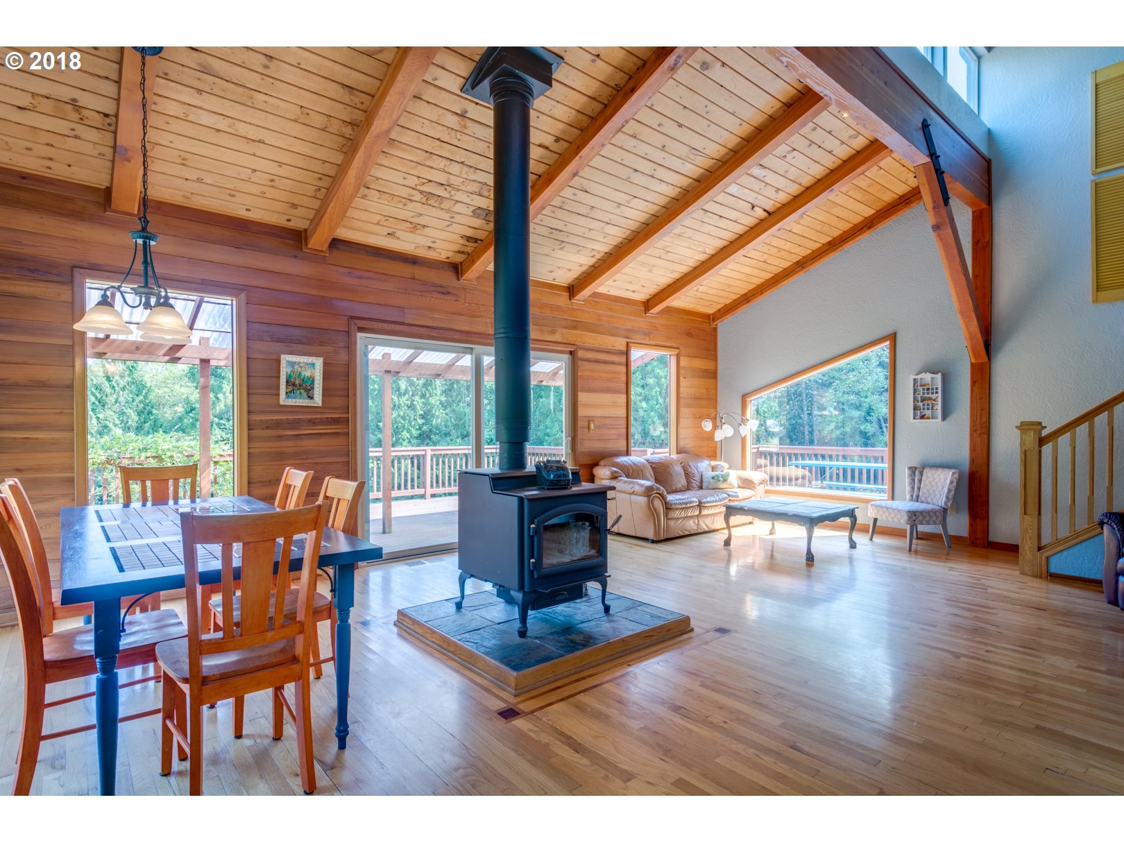 66794 Doetsch Road Deer Island, OR 97054 - Photo 9 of 32 a living room with furniture a fireplace and large windows
