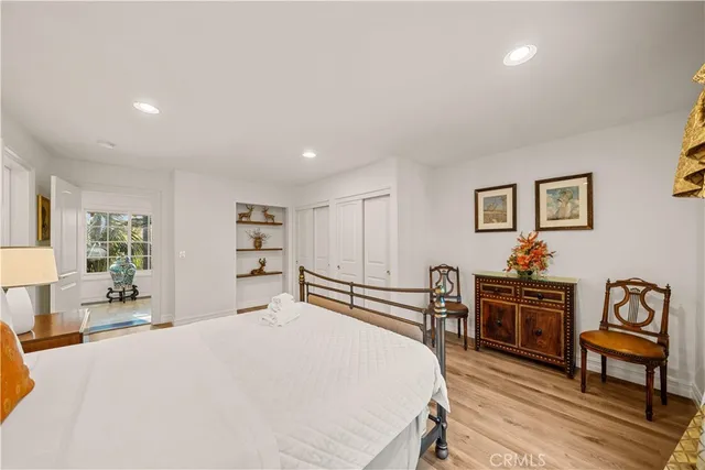 a view of a tennis ground with large trees