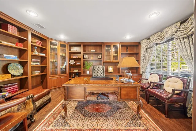 a living room with furniture a fireplace and a large window