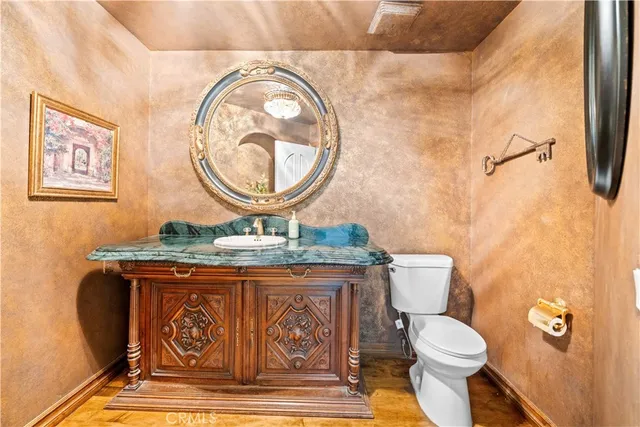 a kitchen with stainless steel appliances kitchen island granite countertop a table and chairs in it