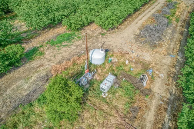 a backyard of a house with a yard and outdoor seating