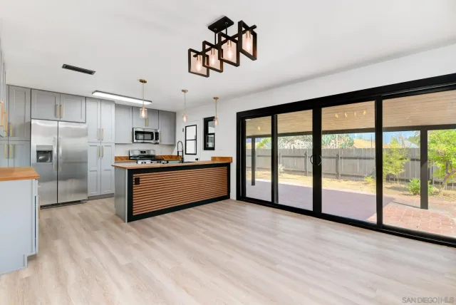 a large kitchen with a large window and stainless steel appliances