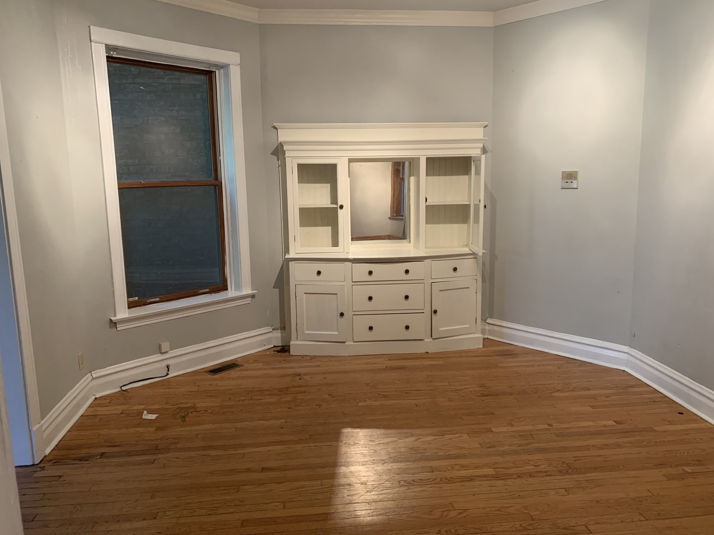 Undisclosed Address Chicago, IL 60613 - Photo 14 of 22 a view of an empty room with wooden floor and cabinet