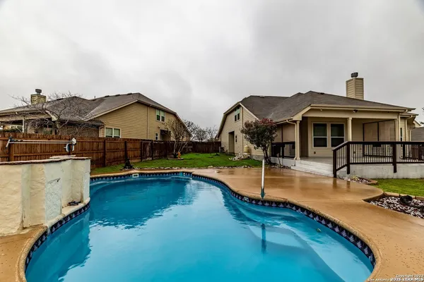 a view of a house with pool and chairs