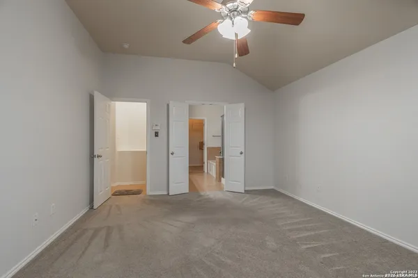 an empty room with a empty space and a ceiling fan