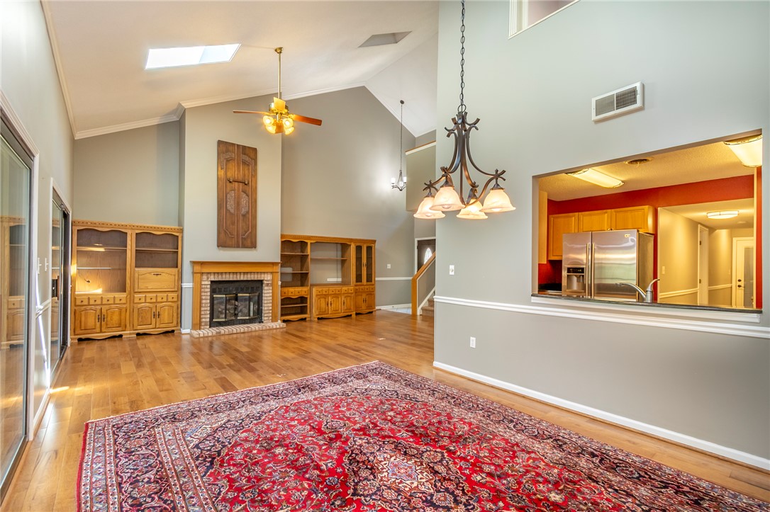 1302 Leeward Road Anderson, SC 29625 - Photo 6 of 50 A fireplace with an elegant brick surround anchors this generously proportioned living area.