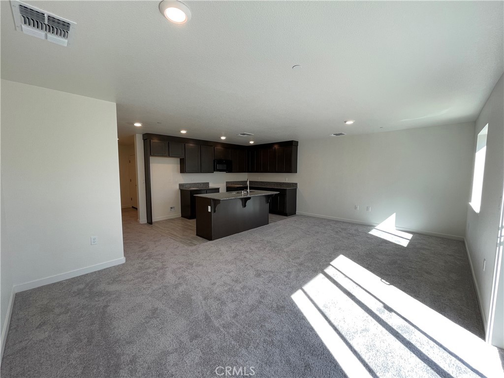 786 Stone Ridge Avenue Merced, CA 95341 - Photo 4 of 8 a room with furniture and a fireplace