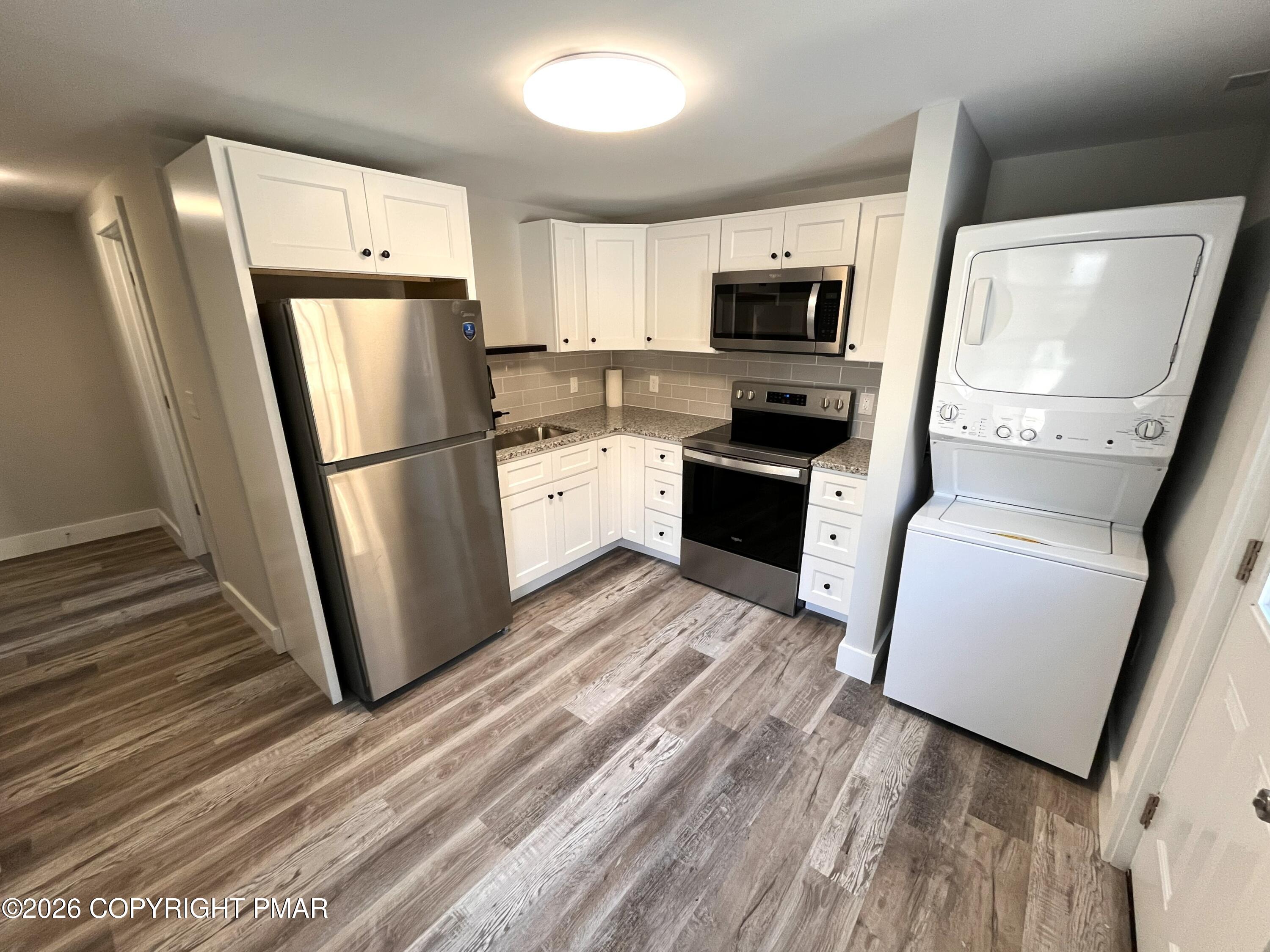 8 Cedar Avenue Jim Thorpe, PA 18229 - Photo 4 of 13 a kitchen with stainless steel appliances a refrigerator stove microwave and sink