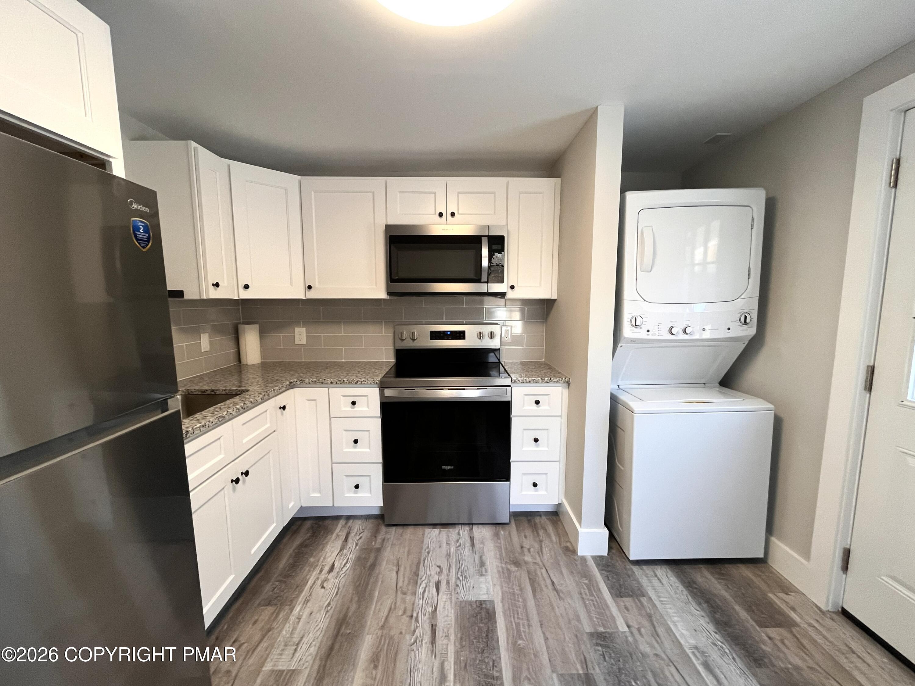 8 Cedar Avenue Jim Thorpe, PA 18229 - Photo 5 of 13 a kitchen with a refrigerator stove and white cabinets