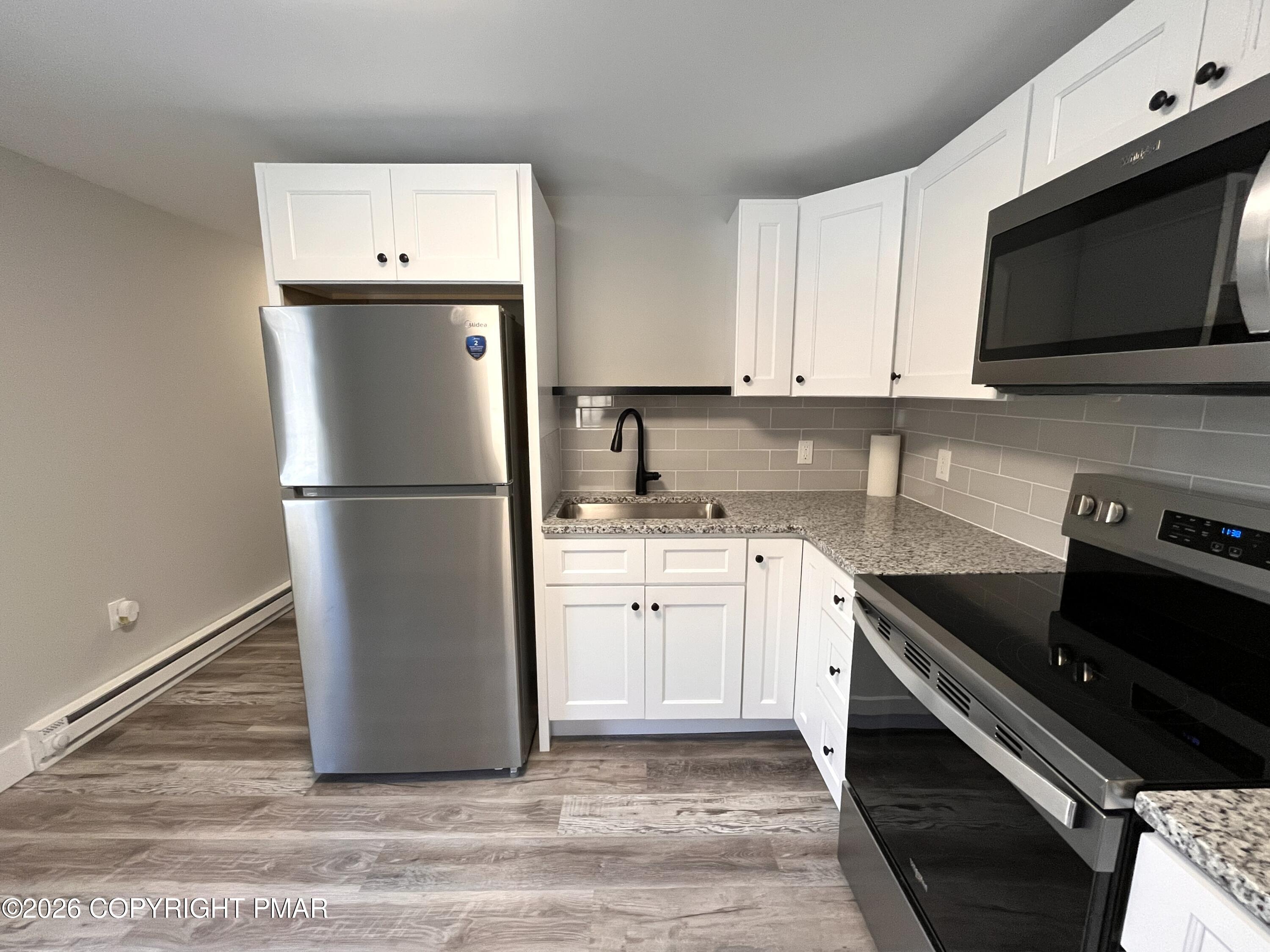 8 Cedar Avenue Jim Thorpe, PA 18229 - Photo 6 of 13 a kitchen with a refrigerator and a stove top oven
