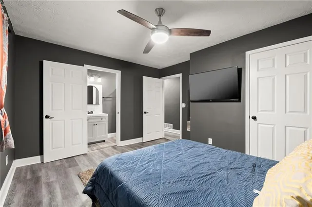 a bedroom with a bed and a chandelier