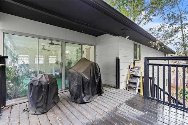 a view of a balcony with furniture and wooden floor