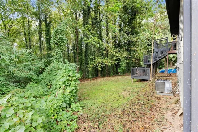 a view of backyard with a large tree