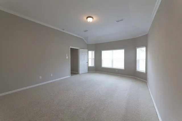 a view of a big room with windows and chandelier fan