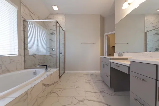 a bathroom with a bathtub sink and mirror
