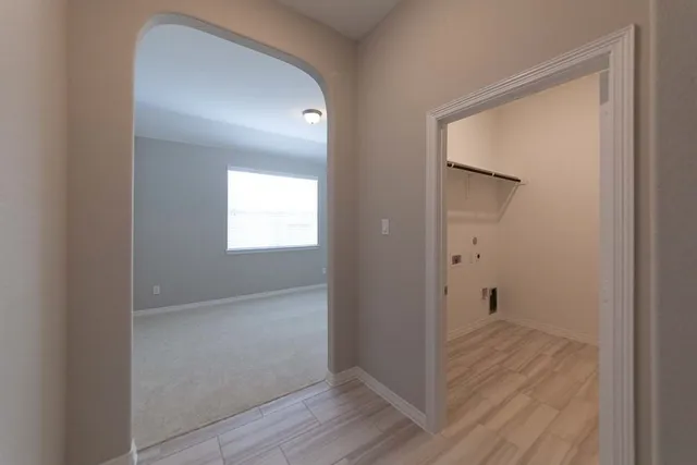 a view of hallway with wooden floor