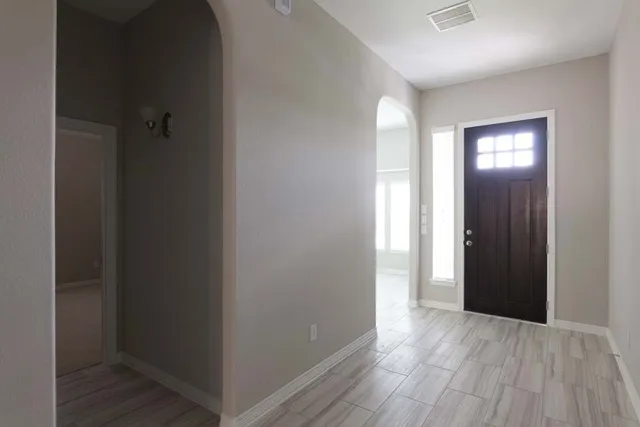 a view of hallway with wooden floor