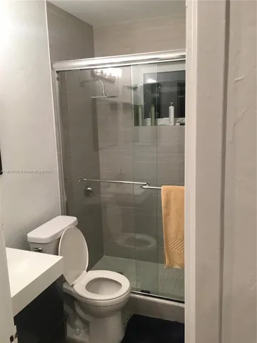 a bathroom with a toilet and a shower