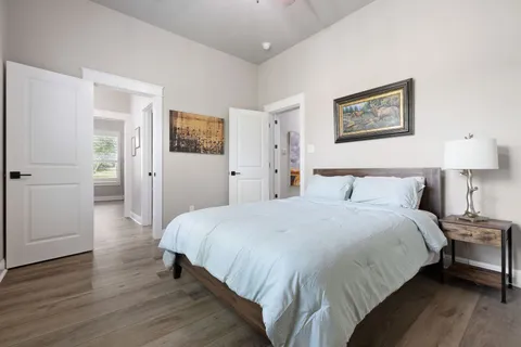 a bedroom with a bed and a lamp on table