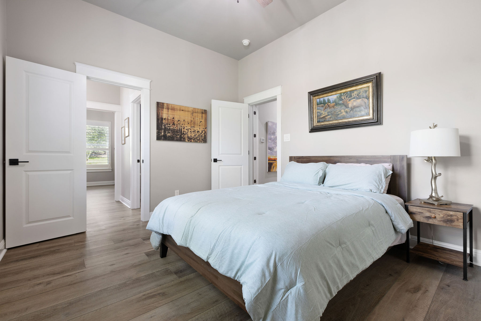 279 Rugged Earth Drive Austin, TX 78737 - Photo 33 of 40 a bedroom with a bed and a lamp on table