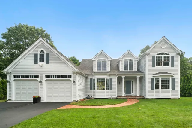 a front view of a house with a yard