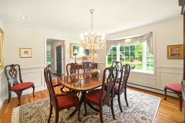 a view of a hallway with furniture and wooden floor