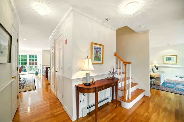 a view of entryway and hall with wooden floor