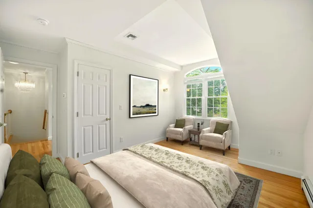 a bedroom with furniture and a window