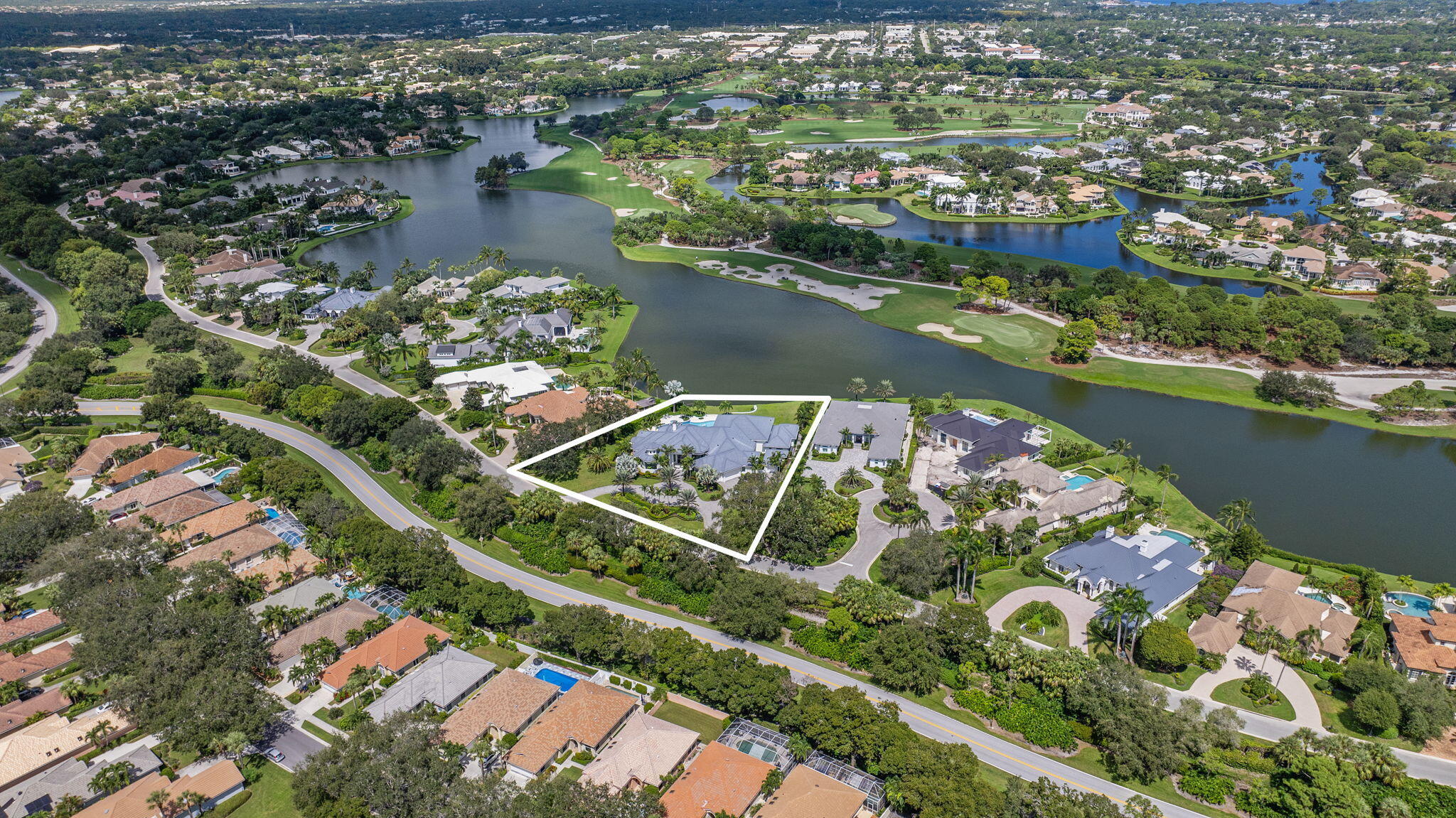 208 Locha Drive Jupiter, FL 33458 - Photo 115 of 125 an aerial view of water body with boats and residential houses with outdoor space