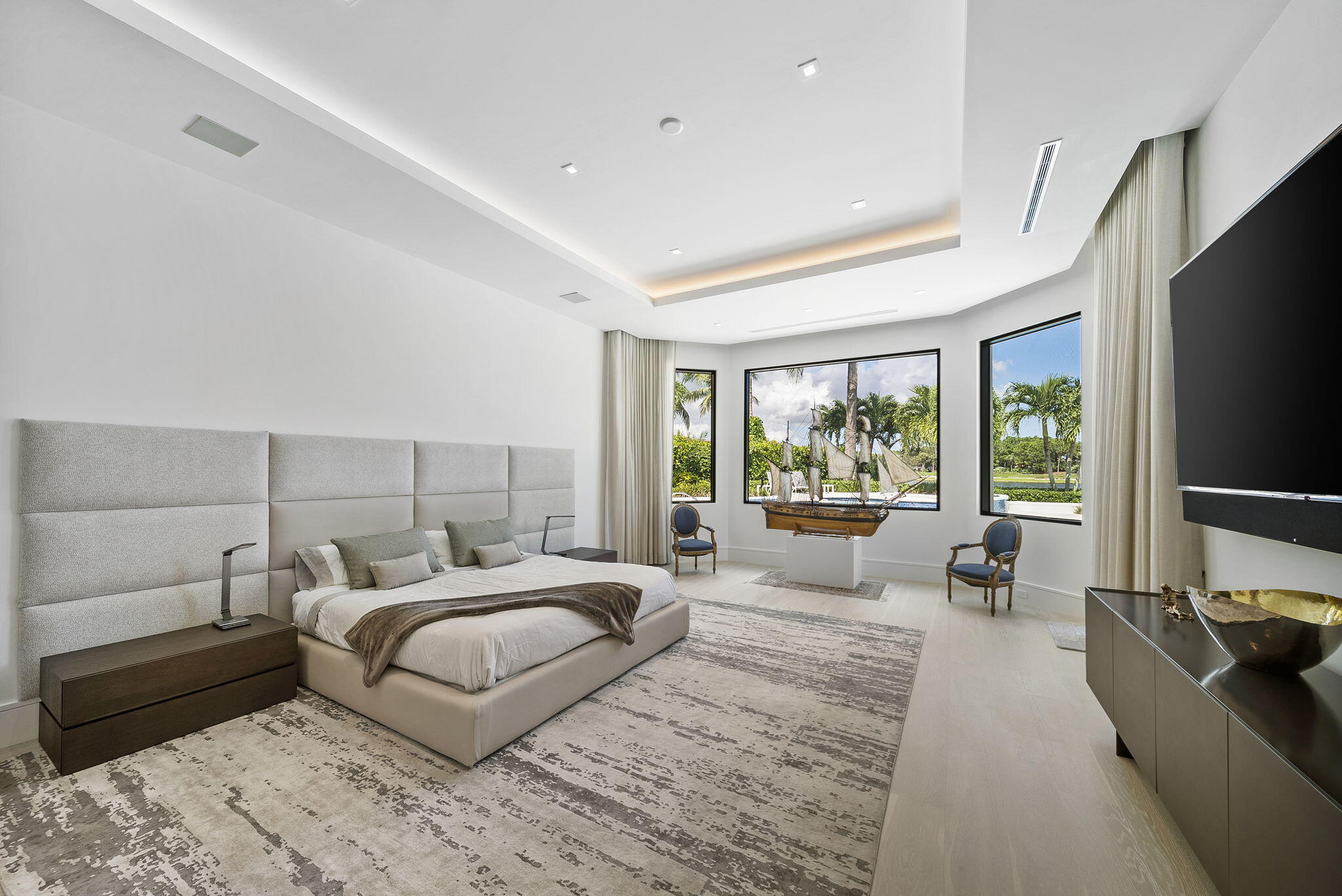 208 Locha Drive Jupiter, FL 33458 - Photo 29 of 125 a bedroom with a large bed and a large window