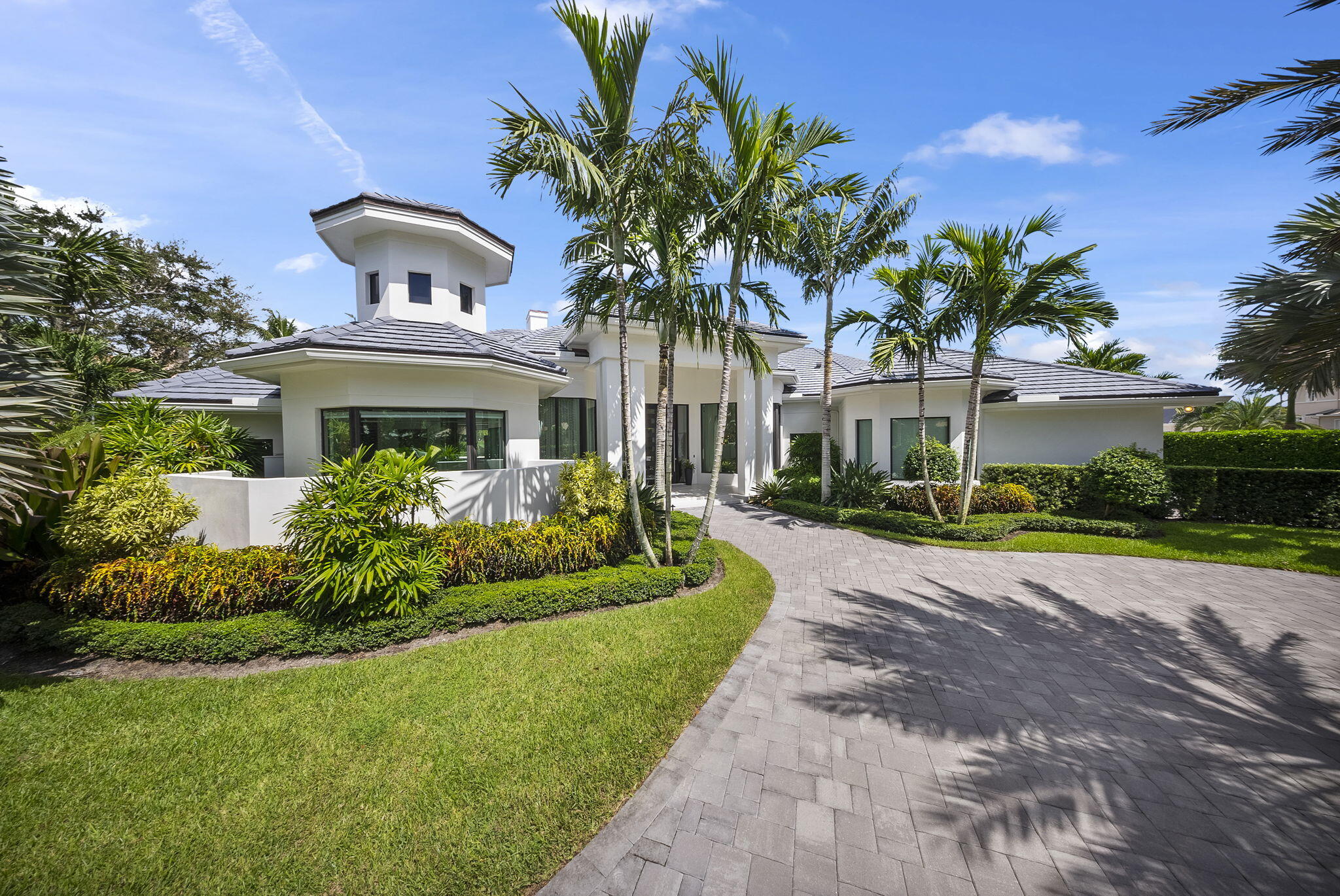 208 Locha Drive Jupiter, FL 33458 - Photo 3 of 125 a front view of a house with a yard and potted plants