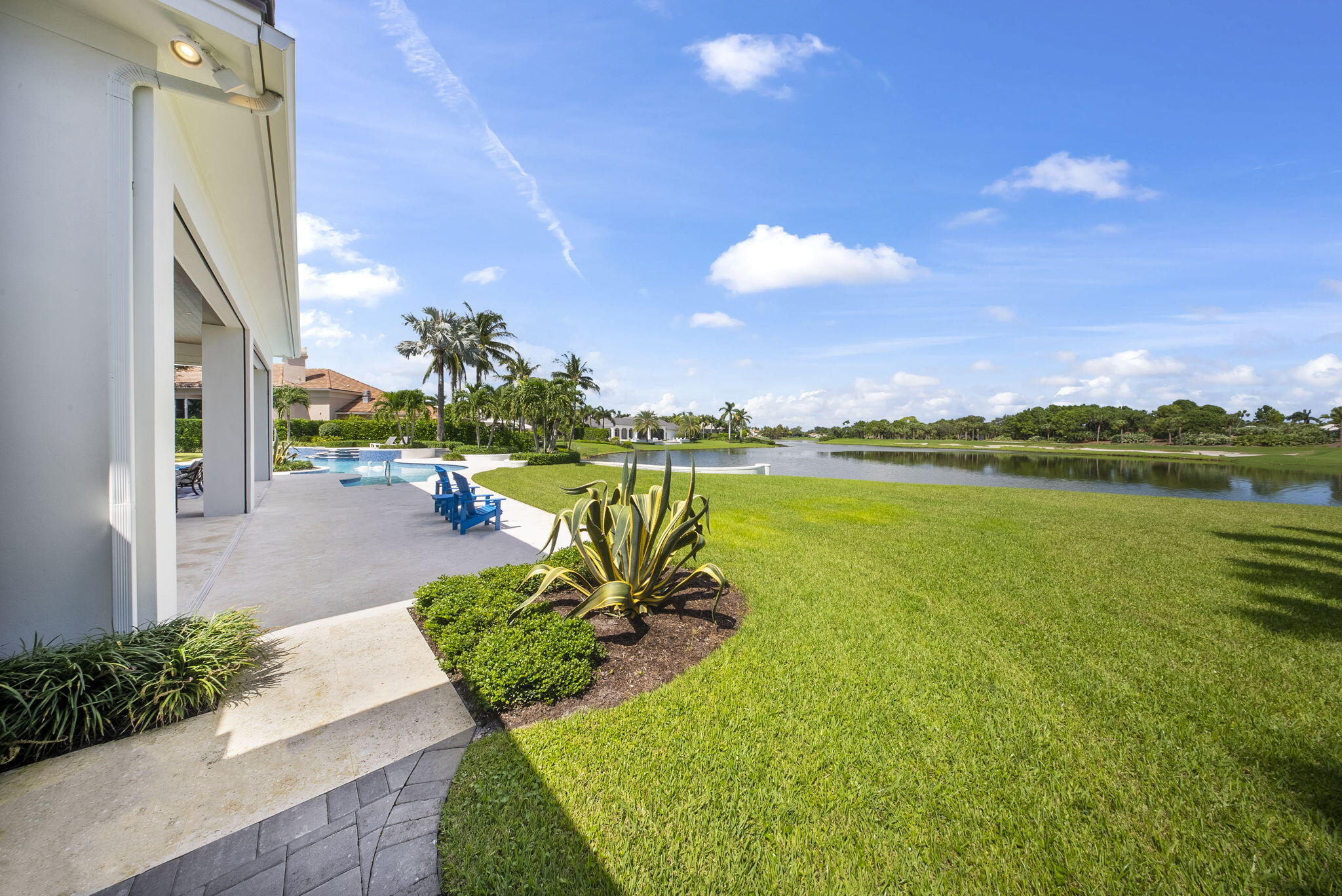 208 Locha Drive Jupiter, FL 33458 - Photo 67 of 125 a view of a lake with a building in the background
