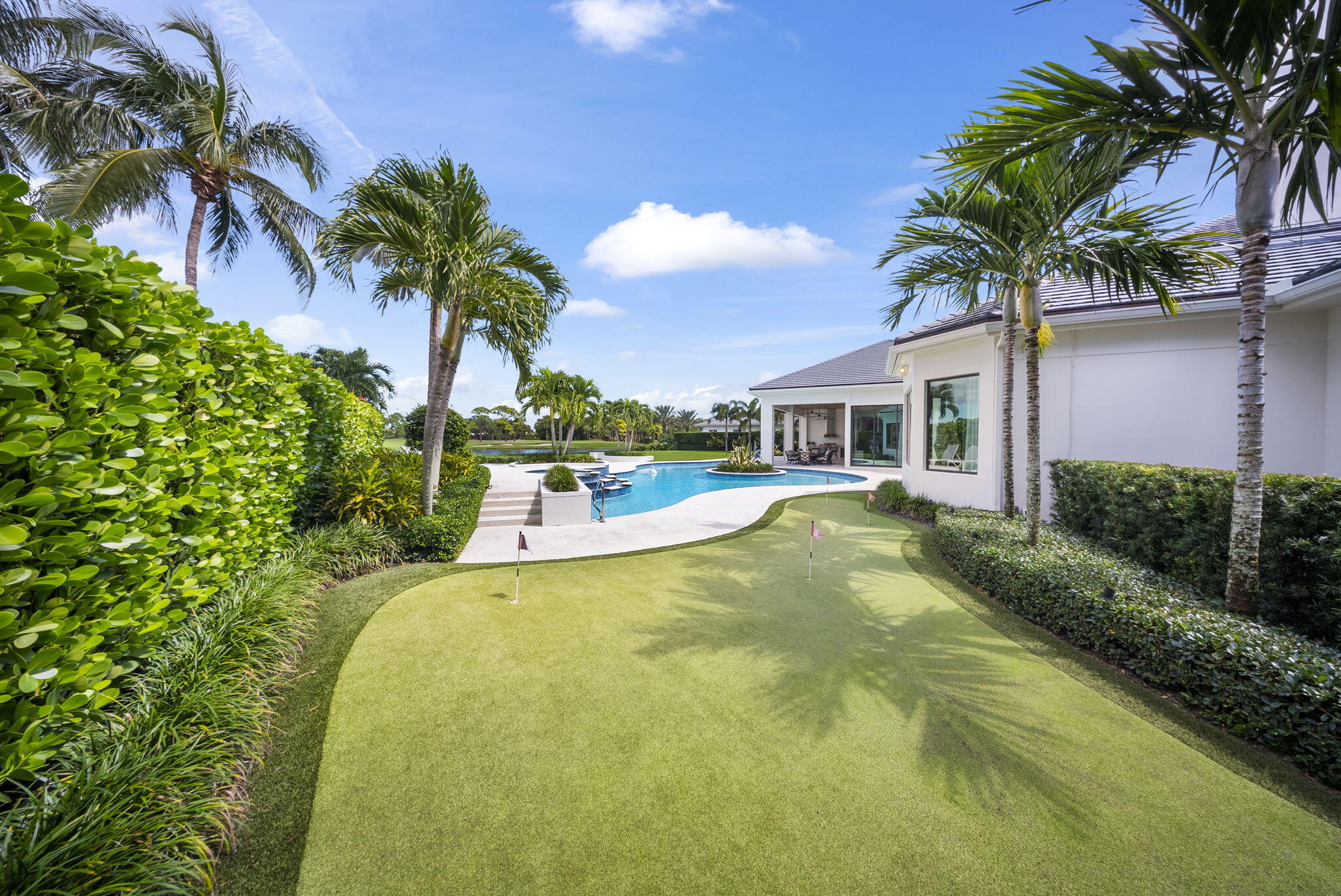 208 Locha Drive Jupiter, FL 33458 - Photo 81 of 125 a view of a house with pool and a trees