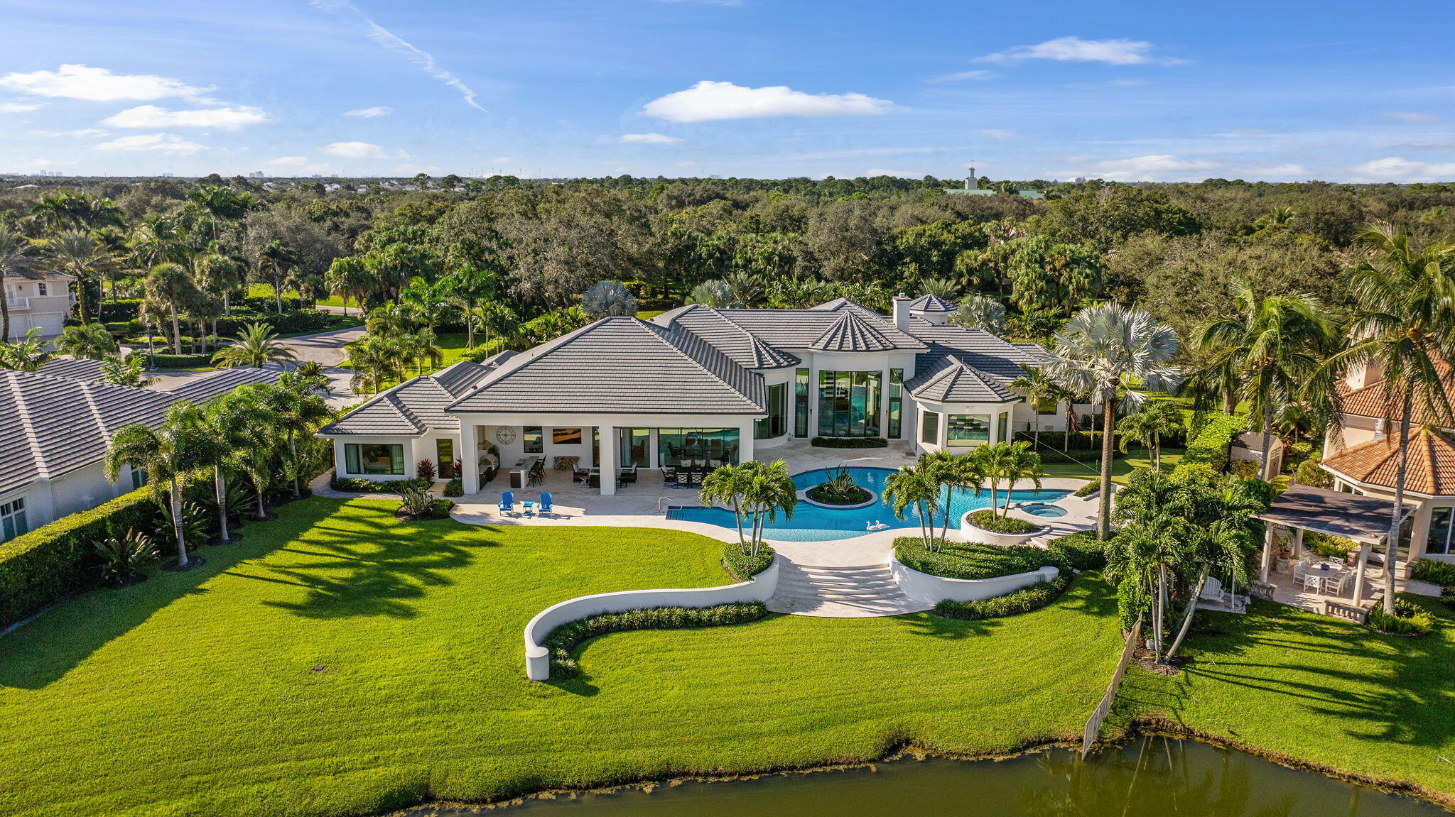 208 Locha Drive Jupiter, FL 33458 - Photo 95 of 125 an aerial view of a house with swimming pool garden view and a lake view