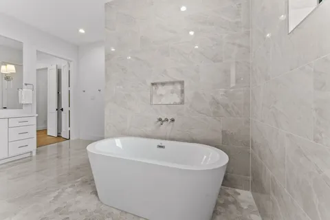 a white bath tub sitting in a bathroom