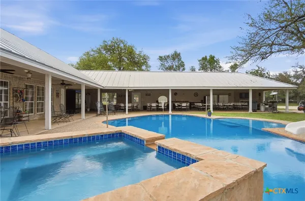 a view of swimming pool with outdoor seating