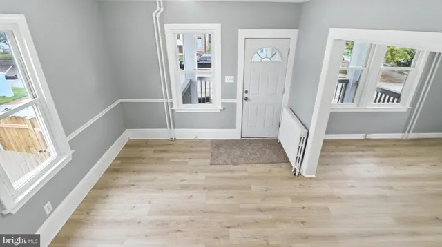 a view of an entryway with wooden floor and door