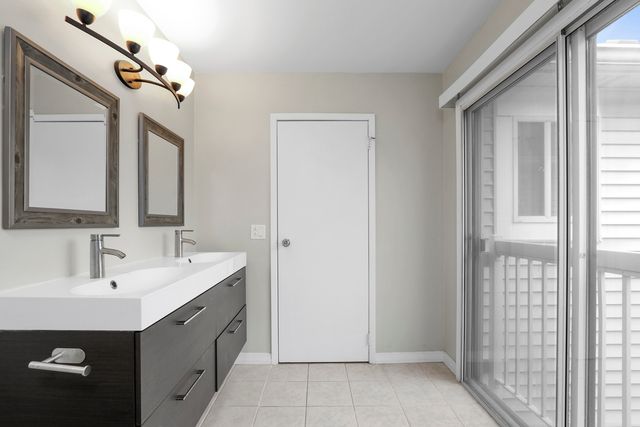 a bathroom with a double vanity sink and a mirror