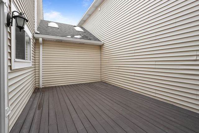 a view of a patio with couches and table and chairs and wooden floor