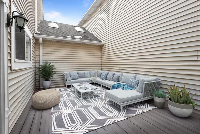a view of a house with wooden deck
