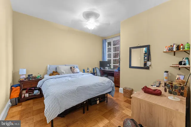 a bedroom with a bed and a dresser in it