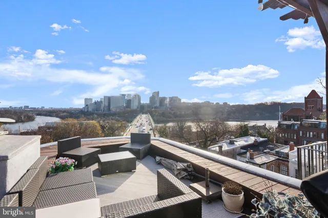 a terrace with outdoor seating and city view