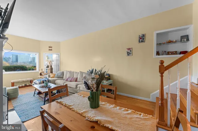 a backyard of a house with barbeque oven table and chairs
