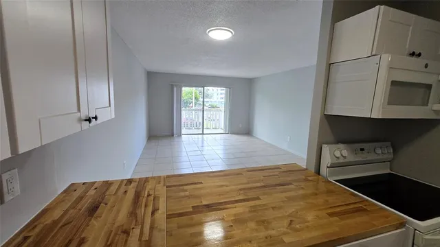 a kitchen with stainless steel appliances a refrigerator and a stove top oven