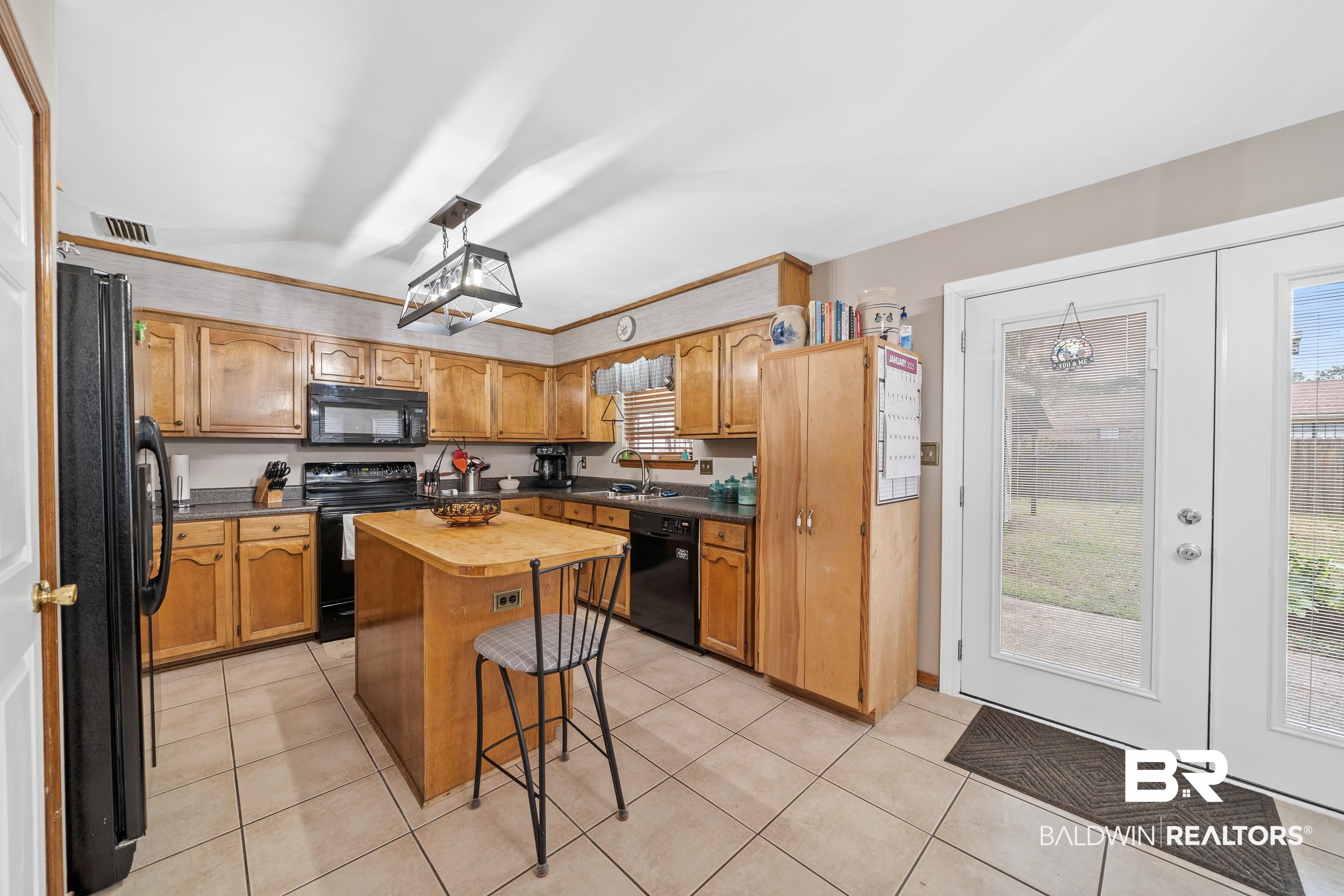 460 Ridgewood Drive Daphne, AL 36526 - Photo 6 of 31 Kitchen featuring sink, a healthy amount of sunlight, a center island, and black appliances