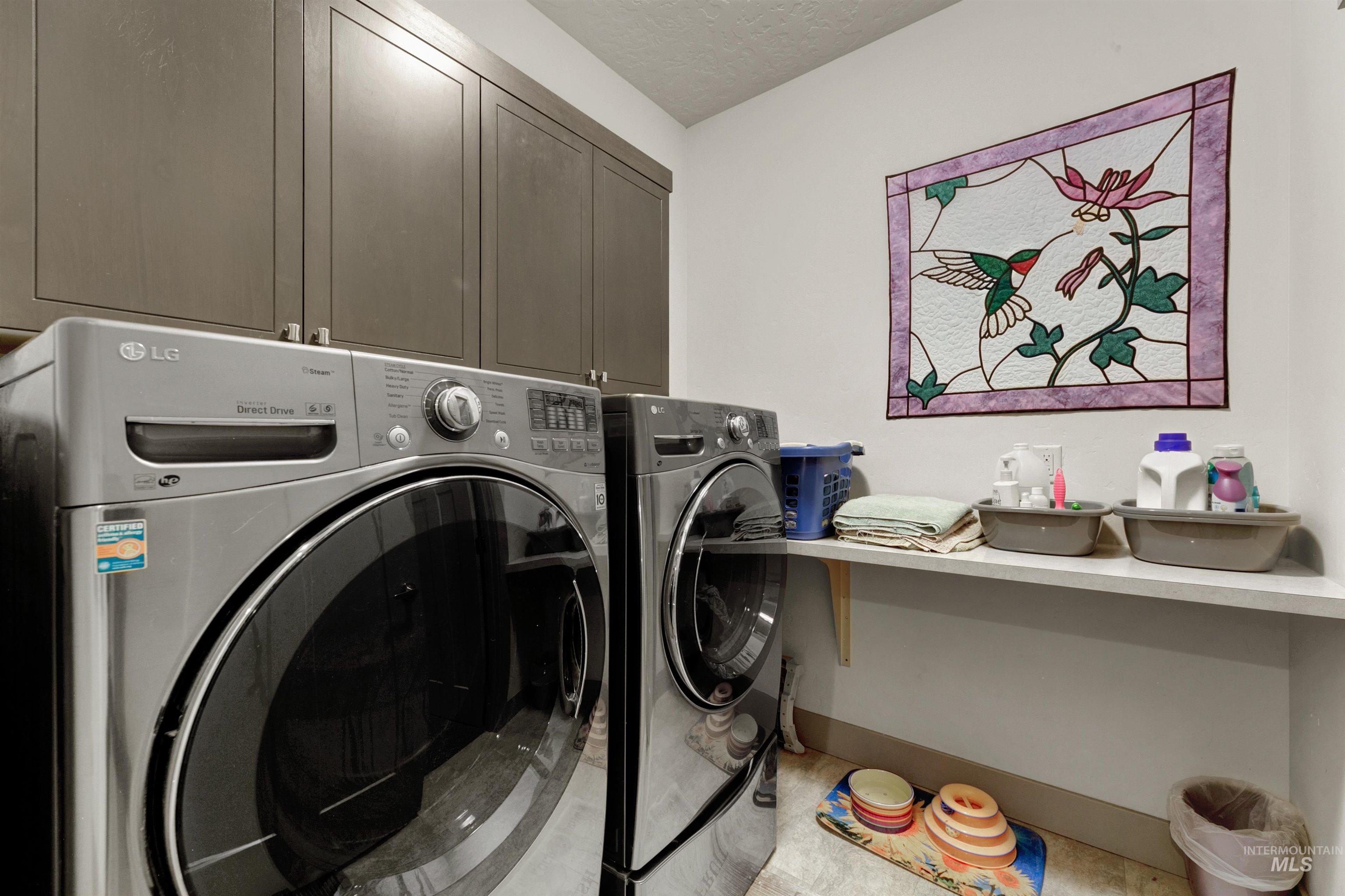 24398 Tombstone Ridge Court Middleton, ID 83644 - Photo 15 of 47 Dedicated laundry area featuring upper cabinetry, a mounted shelf, and a light-toned ceiling