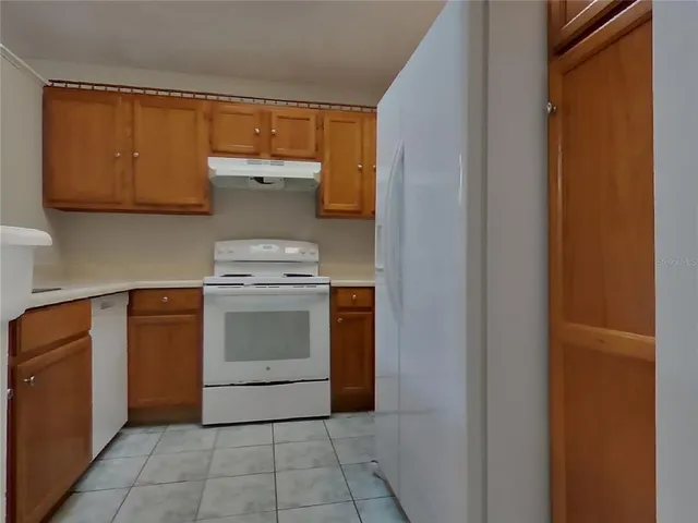 a kitchen with a stove top oven and cabinets